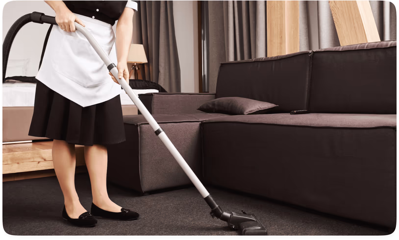 Woman vacums the floor